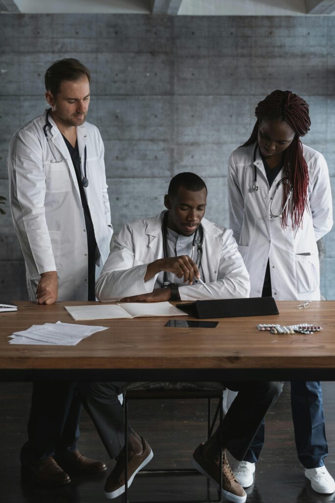 A team of diverse doctors collaborating on medical research in a modern workspace.